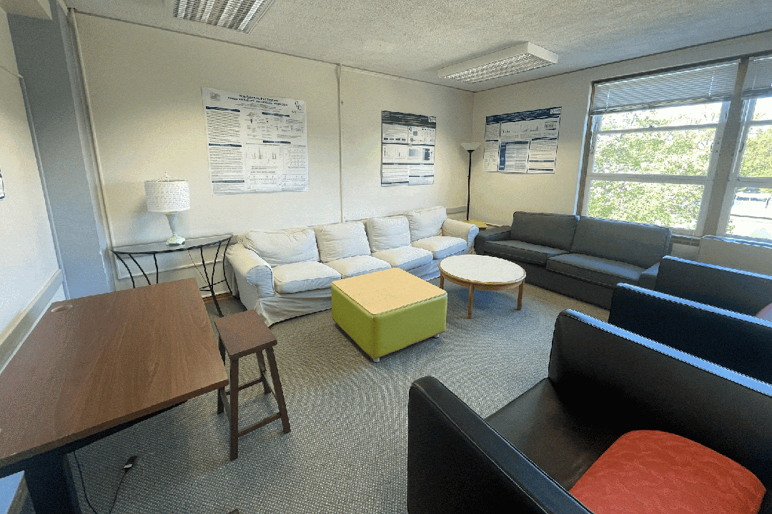 Lounge in the Forensic Sciences Department with leather chairs and couches and a window