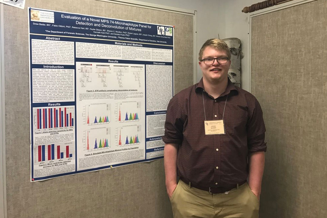 GW Forensic Molecular Biology student Drew Bader stands next to his poster at the 2018 Gordon Research Conference and Seminar.