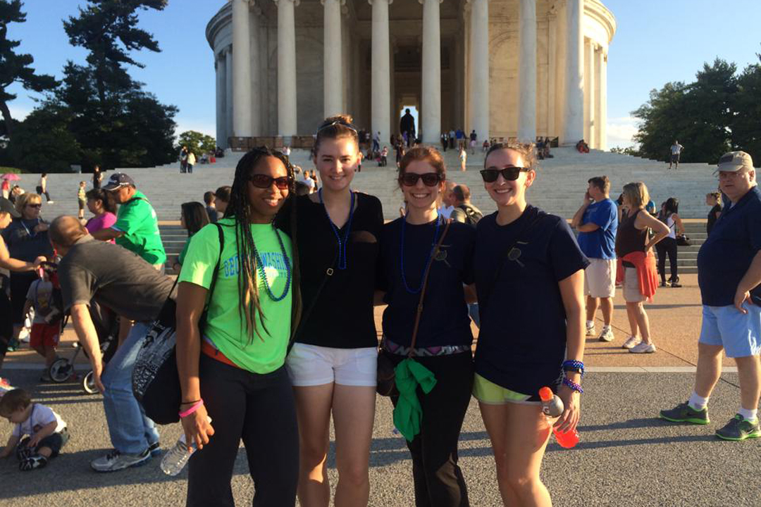 Four members of the Association of Forensic Science Students standing in front of the Jefferson Memorial.