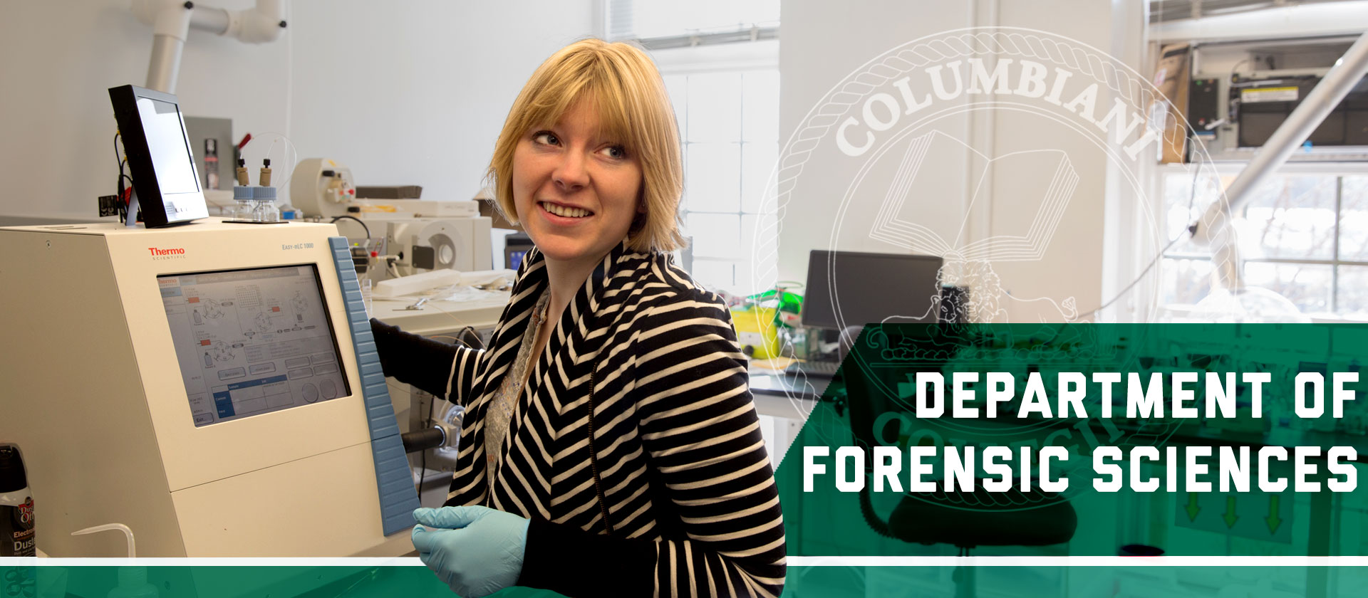 a graduate student in forensic science in a lab in front of a computer