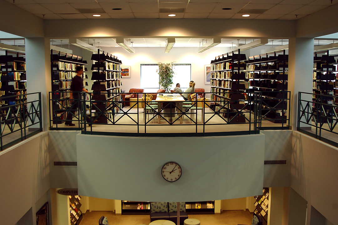 A photo of the Eckles Library interior with stacks of books and computers