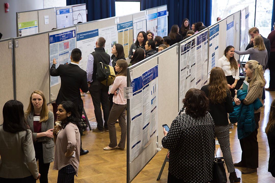 Students walk down corridors of research presentations at GW Research Day
