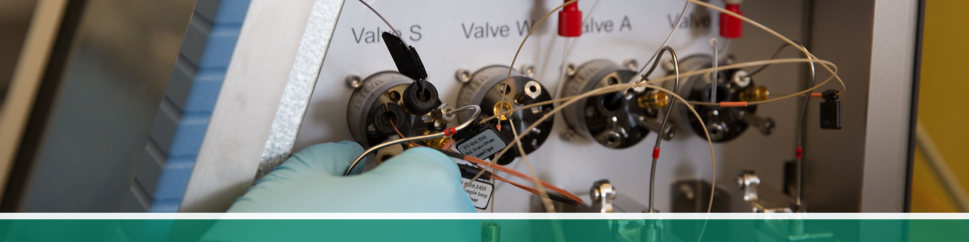 hand plugging in connectors on a machine with valves labeled &quot;Valve S&quot;, &quot;Valve W&quot;, &quot;Valve A&quot;