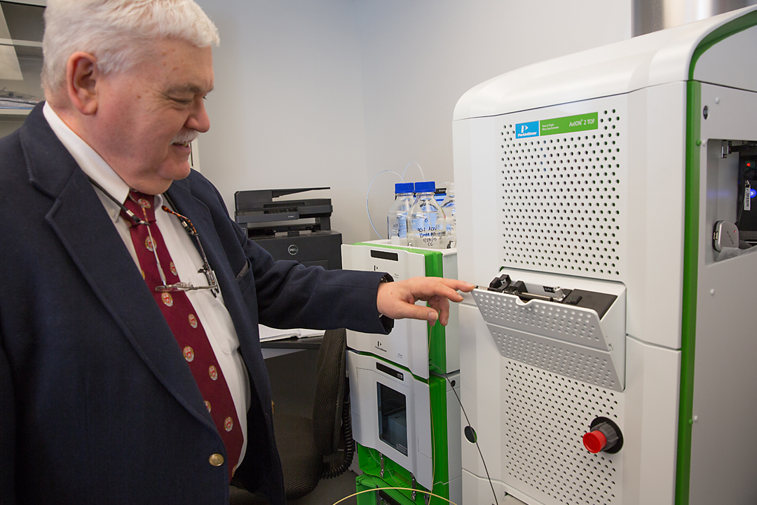 Walter Rowe opening a tray on a PerkinElmer AxION 2TOF mass spectrometer.